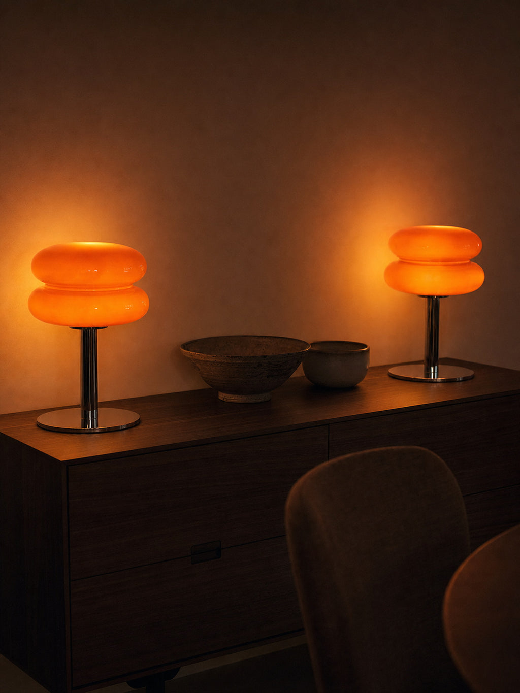 Two Carrara lamps lit side by side on a walnut sideboard, sold individually