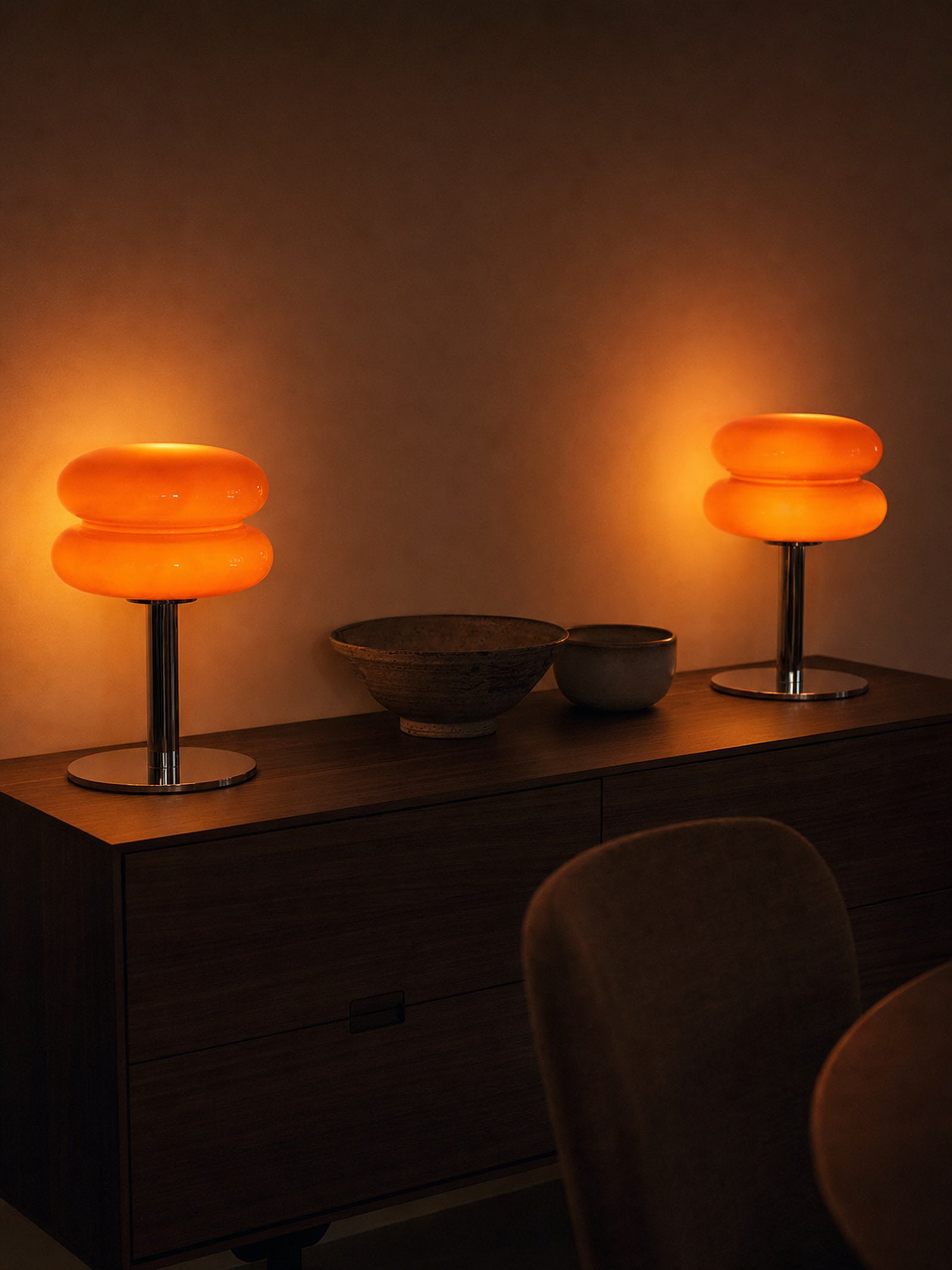 Two Carrara lamps lit side by side on a walnut sideboard, sold individually
