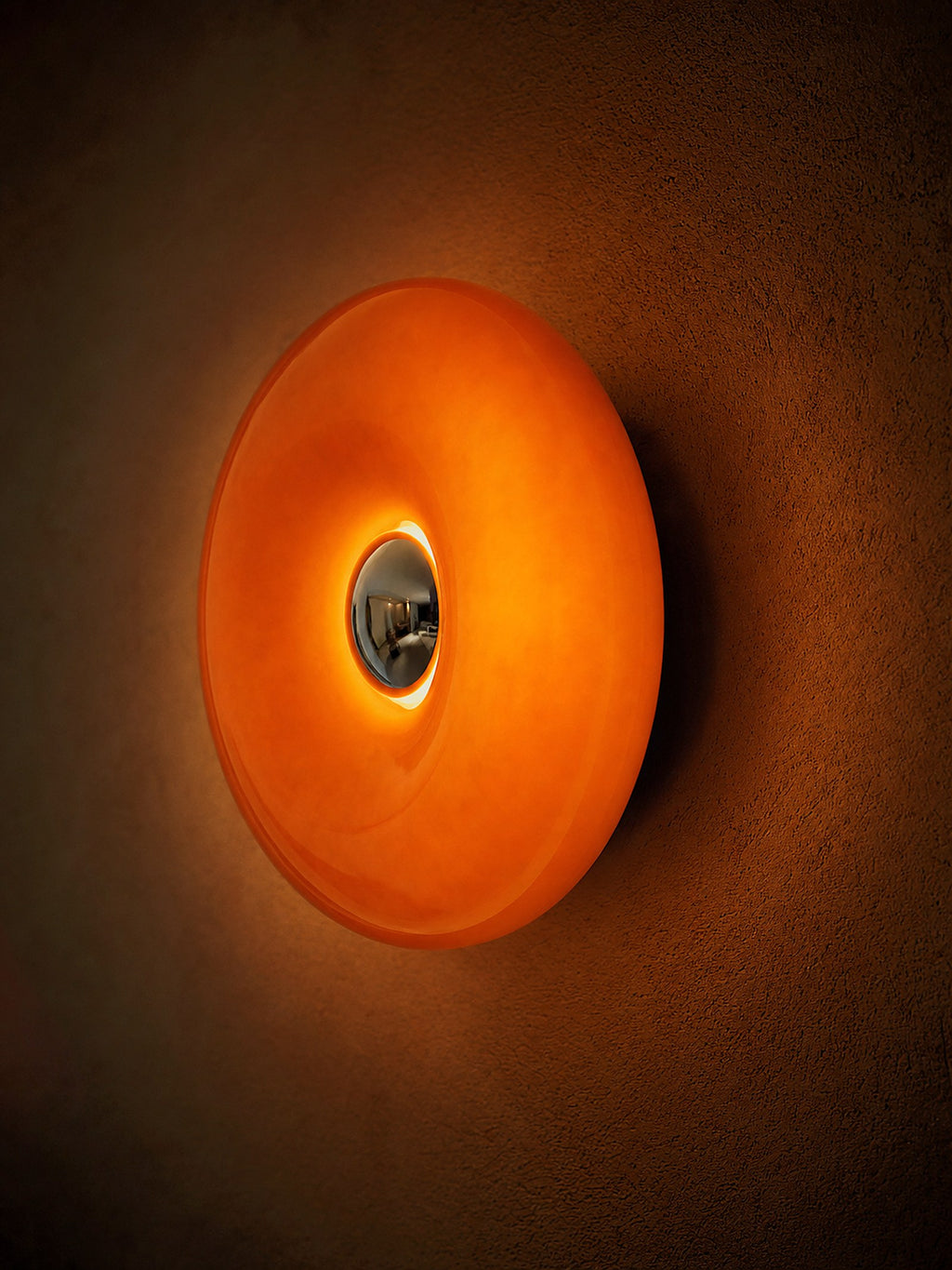 Ember mounted on a wall as a glowing ring, seen at an angle that shows its depth