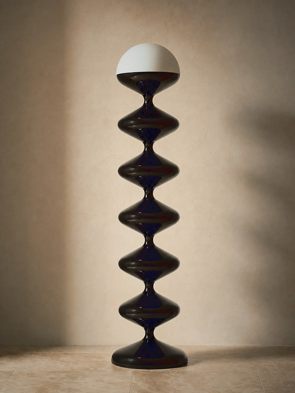 Monolith, a tall black lacquered stacked floor lamp with a white glass dome, unlit