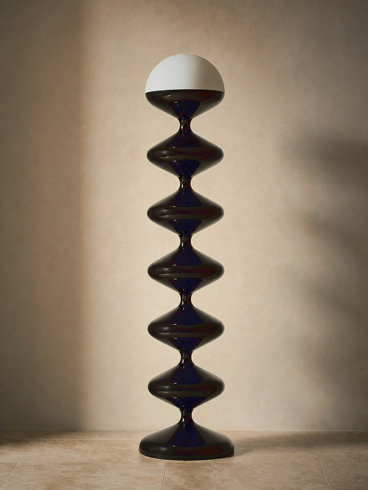 Monolith, a tall black lacquered stacked floor lamp with a white glass dome, unlit