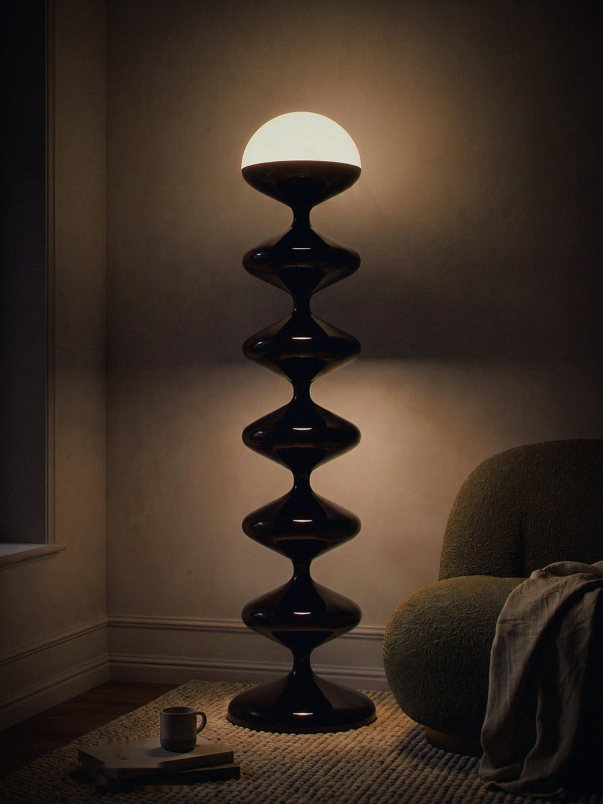 Monolith, a tall black lacquered stacked floor lamp with a white glass dome, switched on in a small living-room corner at night