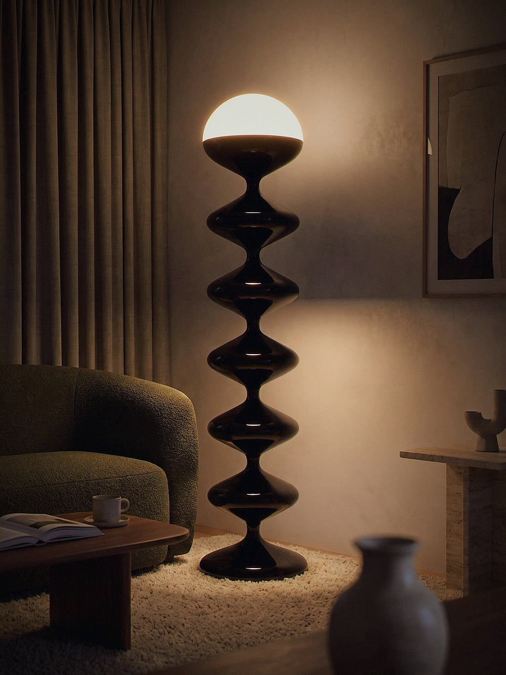 Monolith, a tall black lacquered stacked floor lamp with a white glass dome lit as the only light source in a small living-room corner