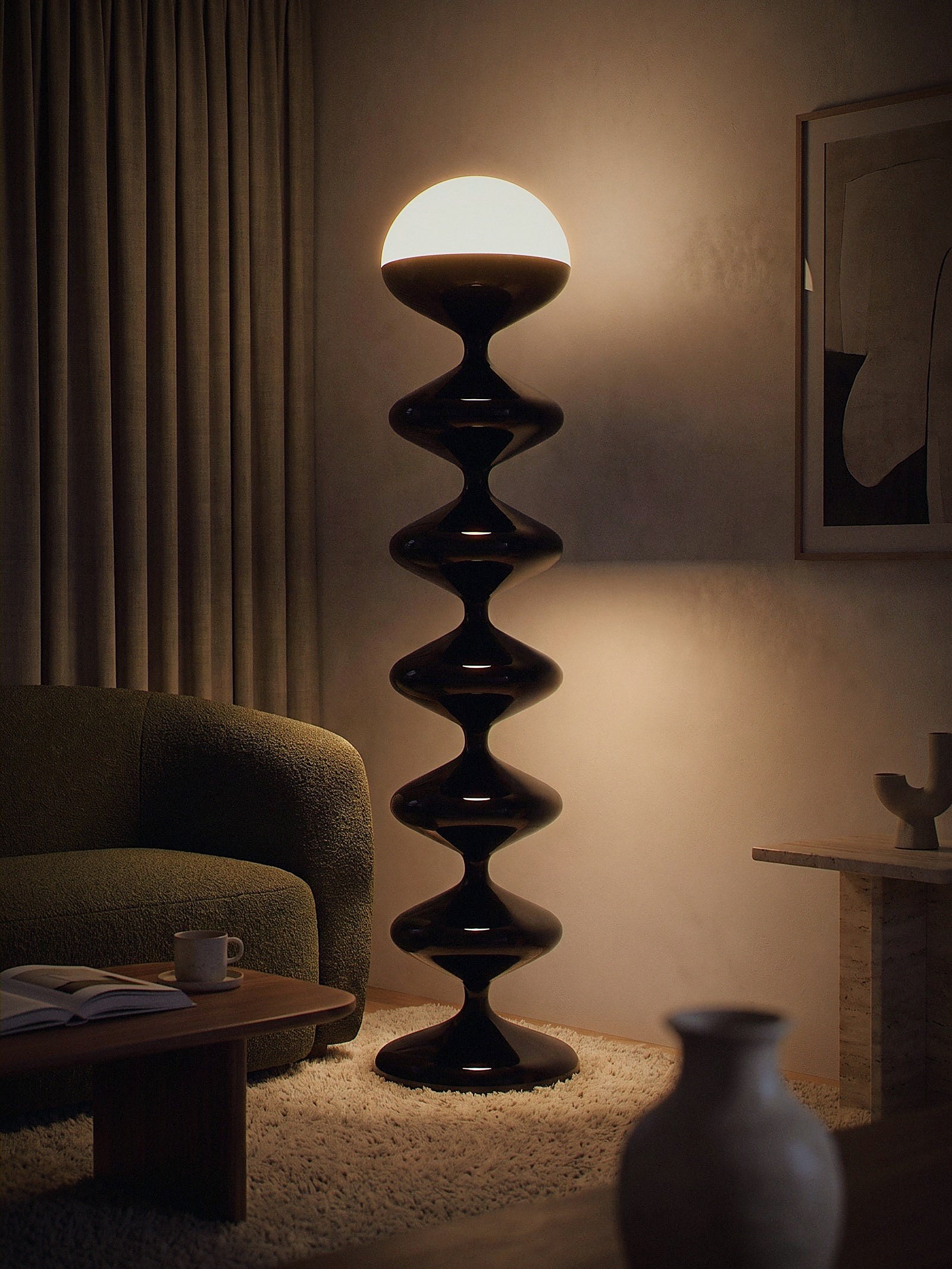 Monolith, a tall black lacquered stacked floor lamp with a white glass dome lit as the only light source in a small living-room corner