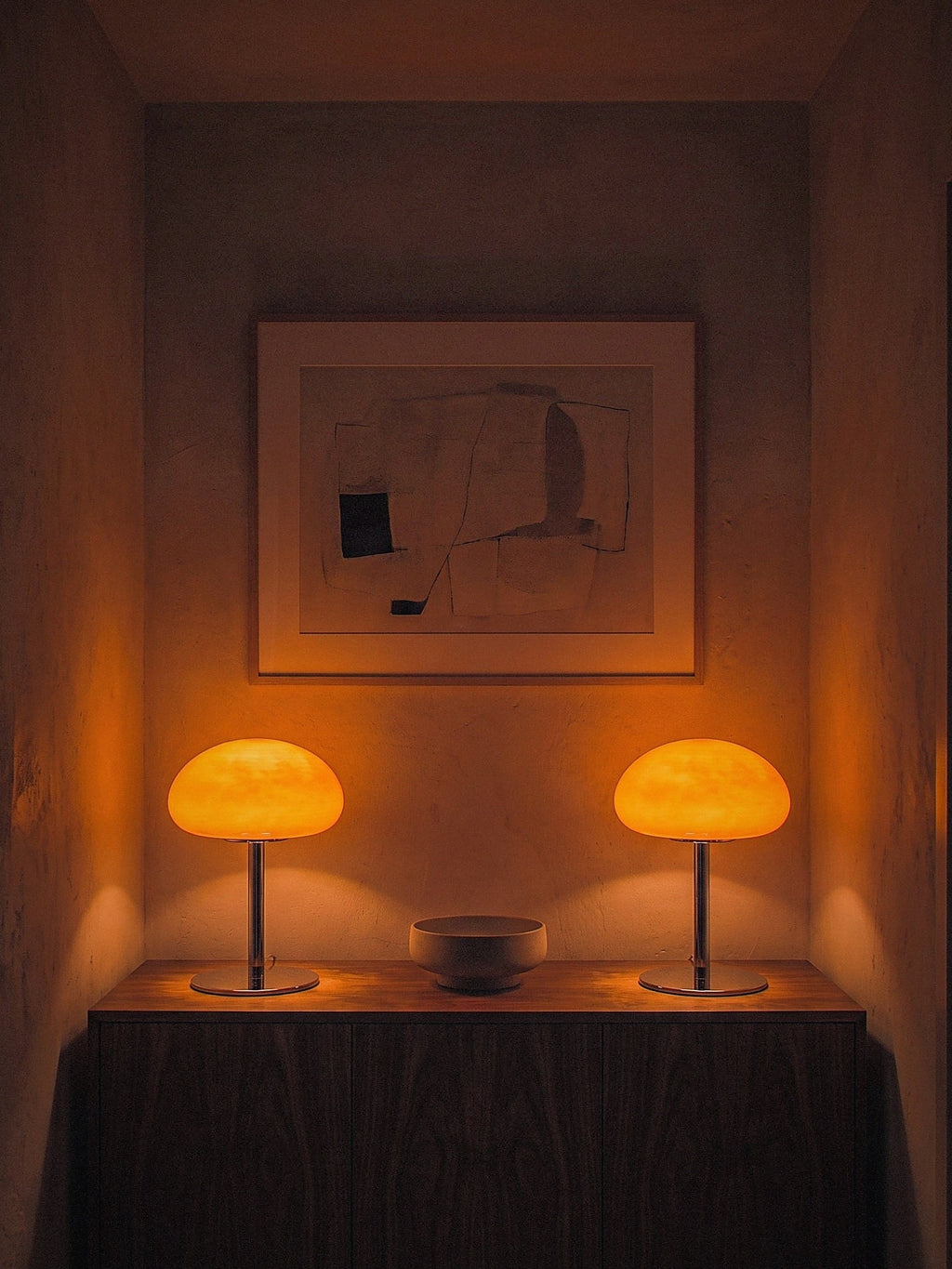 Two Nimbus lamps lit at either end of a dark console, sold individually