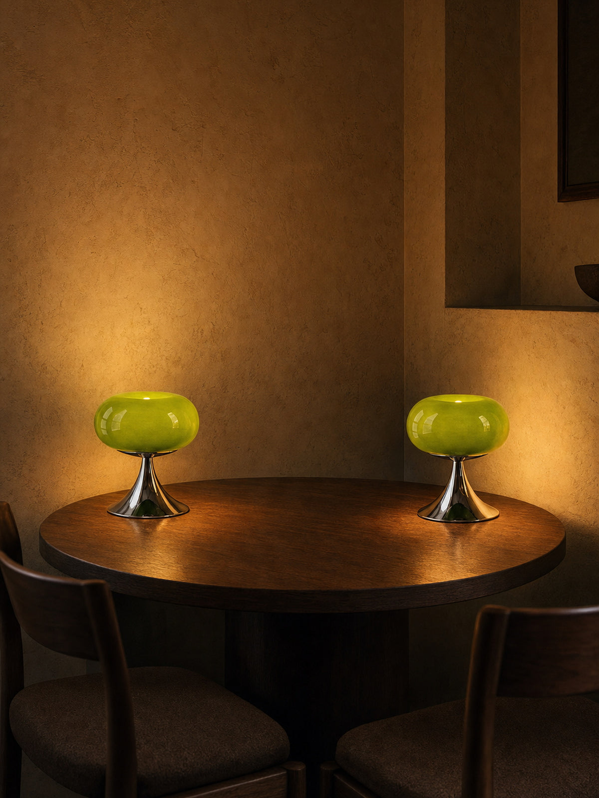 Two Rondo lamps lit together on a round dining table, sold individually