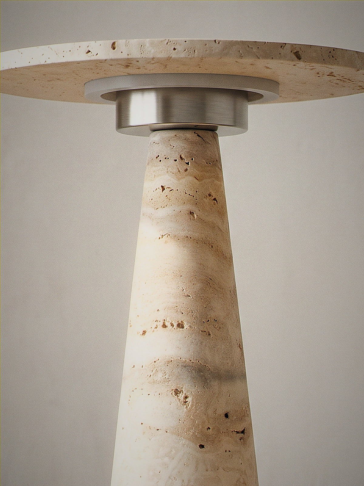 Close detail of Terrazzo, a travertine cone topped with a travertine disc over a chrome ring diffuser