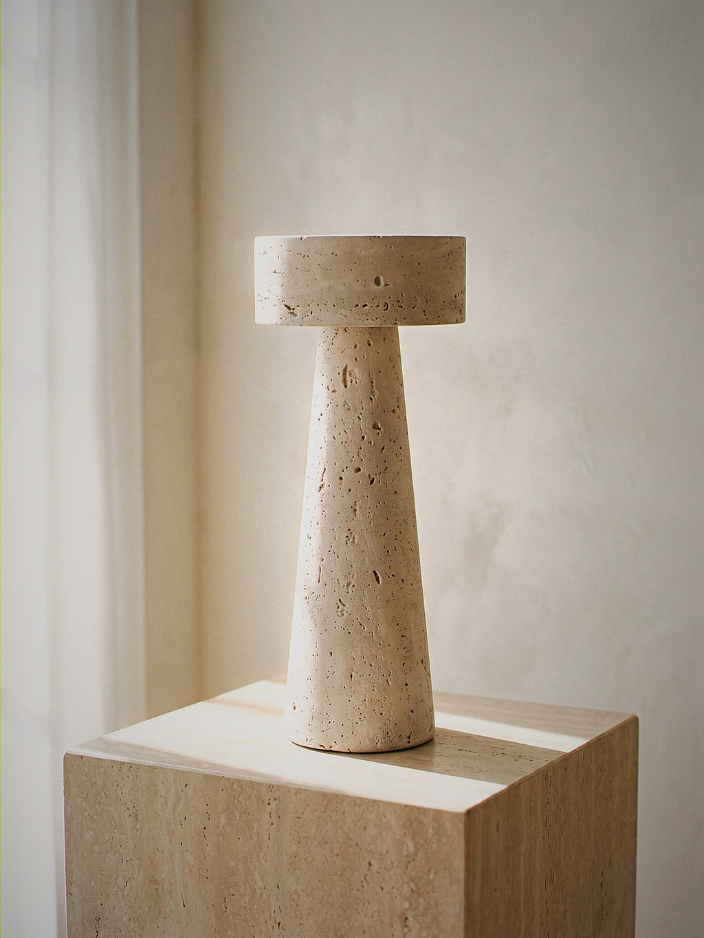 Zen, a tapered travertine column topped with a stone disc, unlit